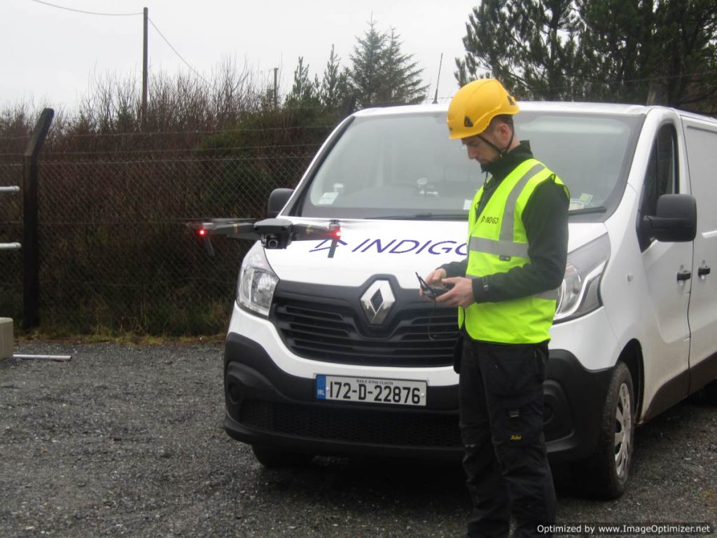 Indigo engineer flying a drone beside Indigo van